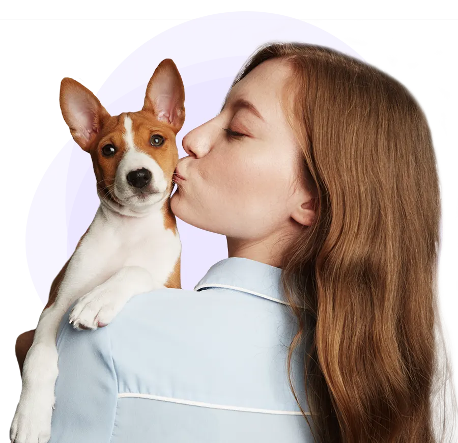Woman kisses small brown and white dog
